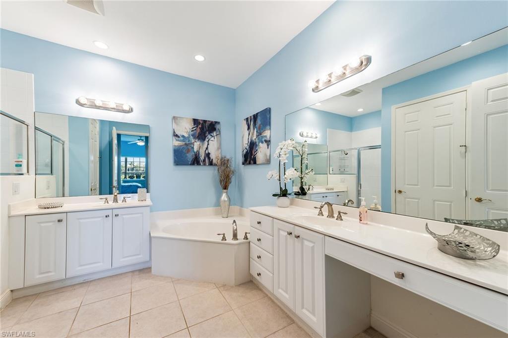 9275 Museo Circle, Unit 103 Naples, FL 34114 - Photo 15 of 49 a large bathroom with a double vanity sink mirror and bathtub