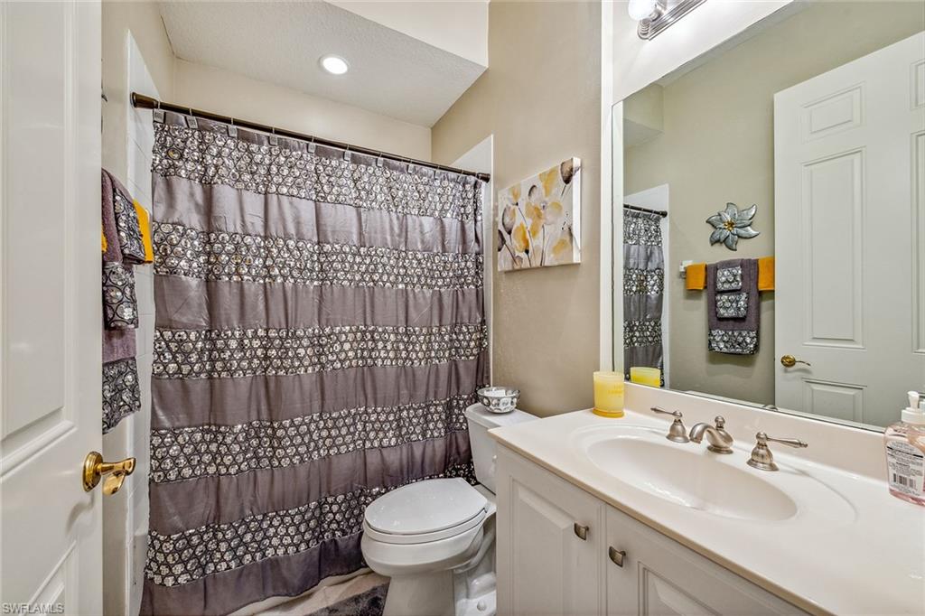 9275 Museo Circle, Unit 103 Naples, FL 34114 - Photo 18 of 49 a bathroom with a sink toilet vanity and shower