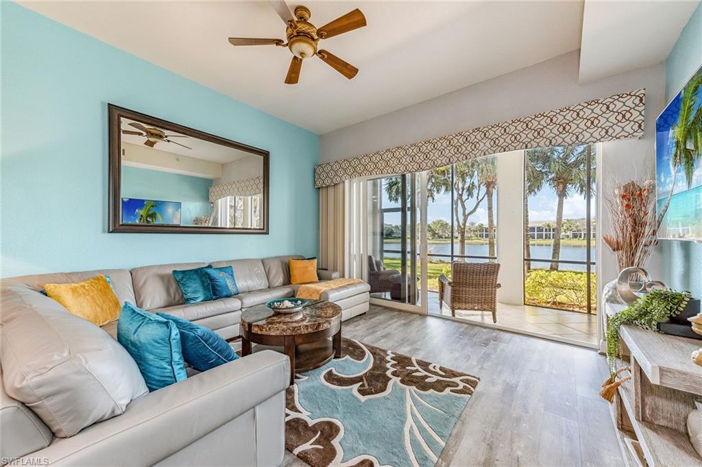 9275 Museo Circle, Unit 103 Naples, FL 34114 - Photo 2 of 49 a living room with furniture and a large window