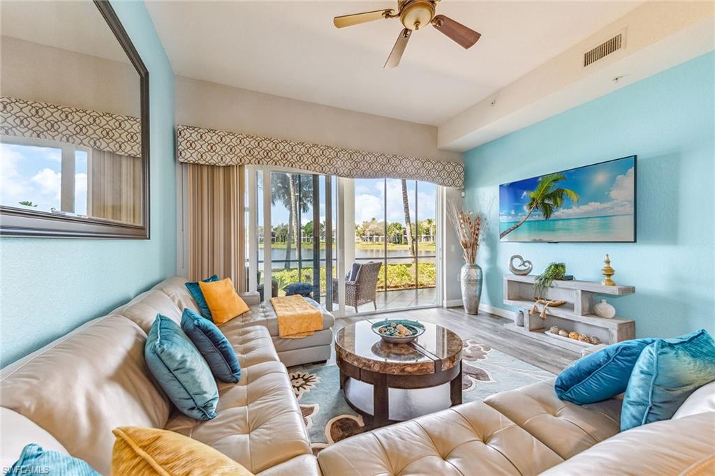 9275 Museo Circle, Unit 103 Naples, FL 34114 - Photo 5 of 49 a living room with furniture and a flat screen tv
