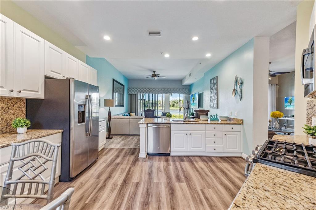 9275 Museo Circle, Unit 103 Naples, FL 34114 - Photo 8 of 49 a kitchen with refrigerator and cabinets