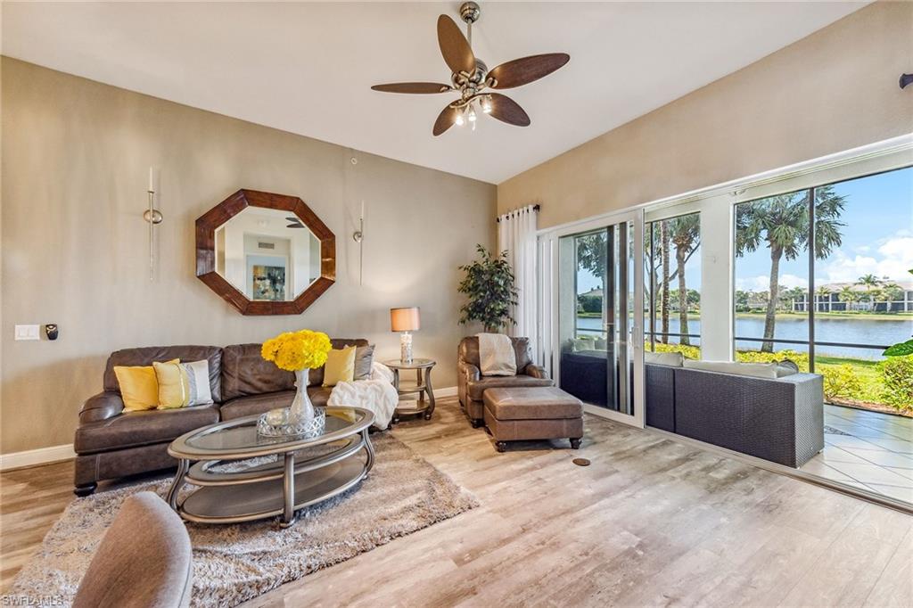 9275 Museo Circle, Unit 103 Naples, FL 34114 - Photo 10 of 49 a living room with furniture and a large window