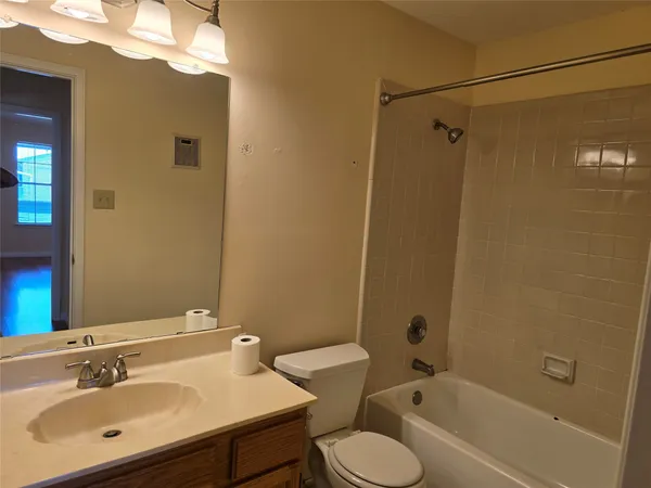 a bathroom with a sink mirror toilet and bathtub