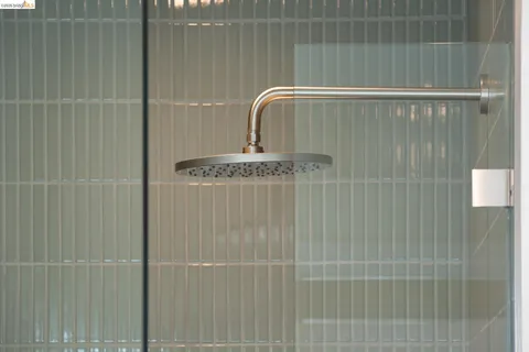 a bedroom with a bed and glass window