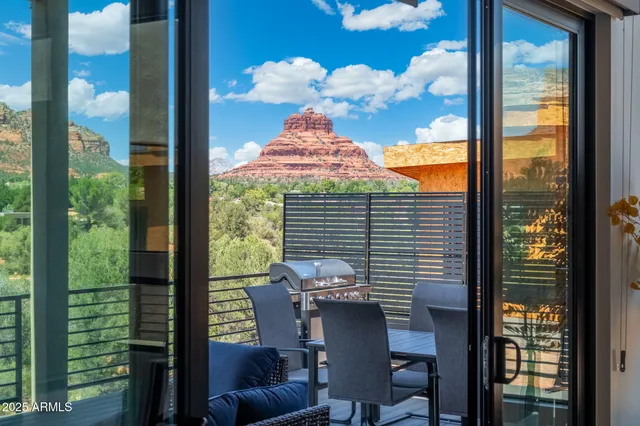 a kitchen with stainless steel appliances kitchen island a table and chairs in it