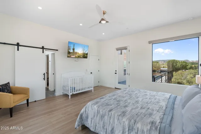 a bedroom with a large bed and a chandelier