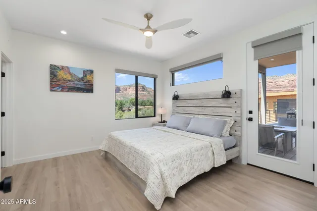 a bedroom with a bed and a painting on the wall