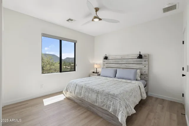 a kitchen with white cabinets and sink