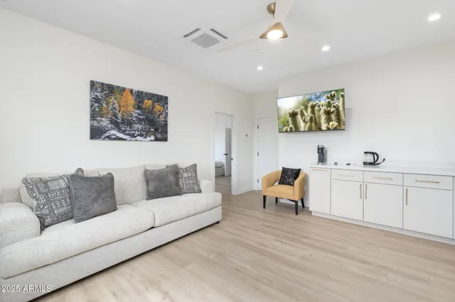 a living room with furniture and a chandelier