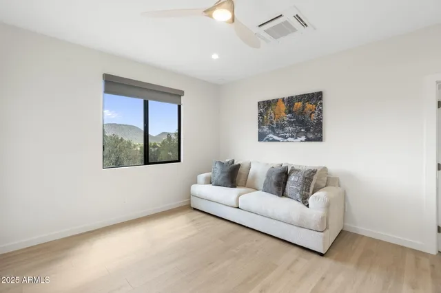 a living room with furniture city view and large windows