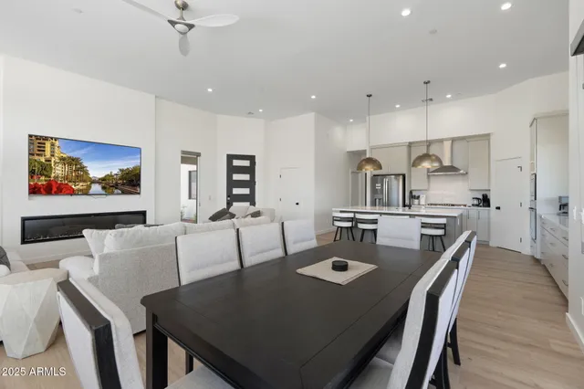 a kitchen with a table chairs and a refrigerator