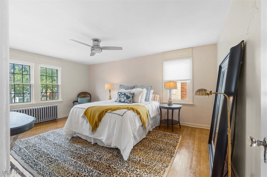 3609 Northcliffe Road University Heights, OH 44118 - Photo 17 of 26 Bedroom featuring radiator, wood finished floors, and ceiling fan