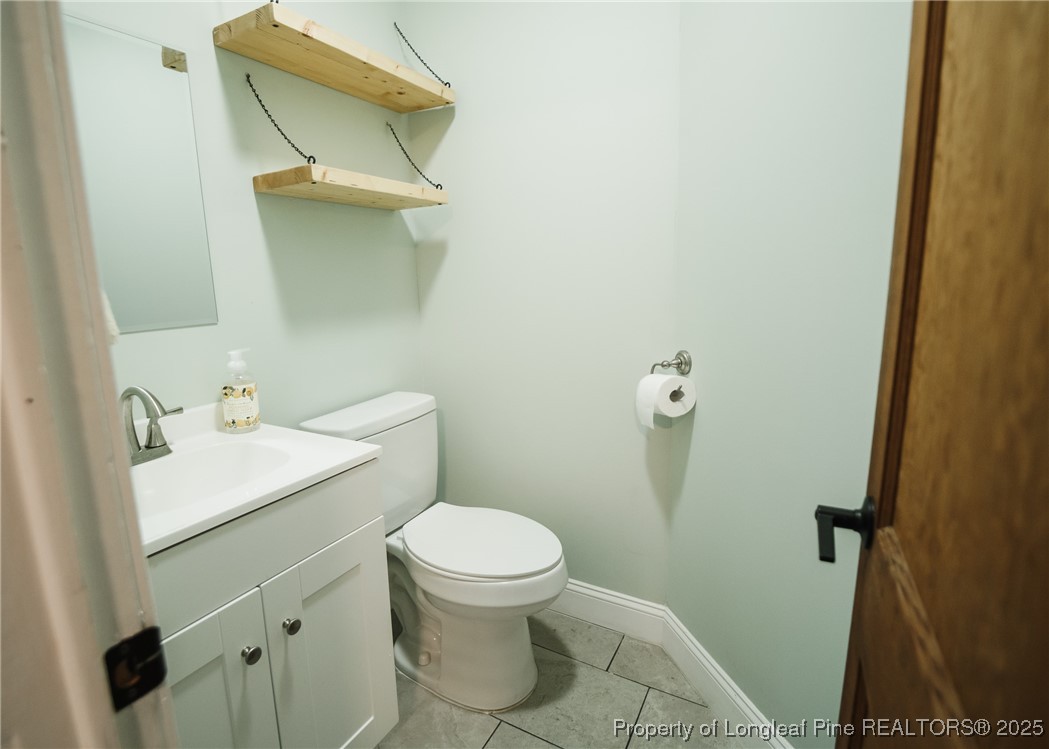 9778 Highway 24 Carthage, NC 28327 - Photo 19 of 47 a bathroom with a sink toilet and vanity