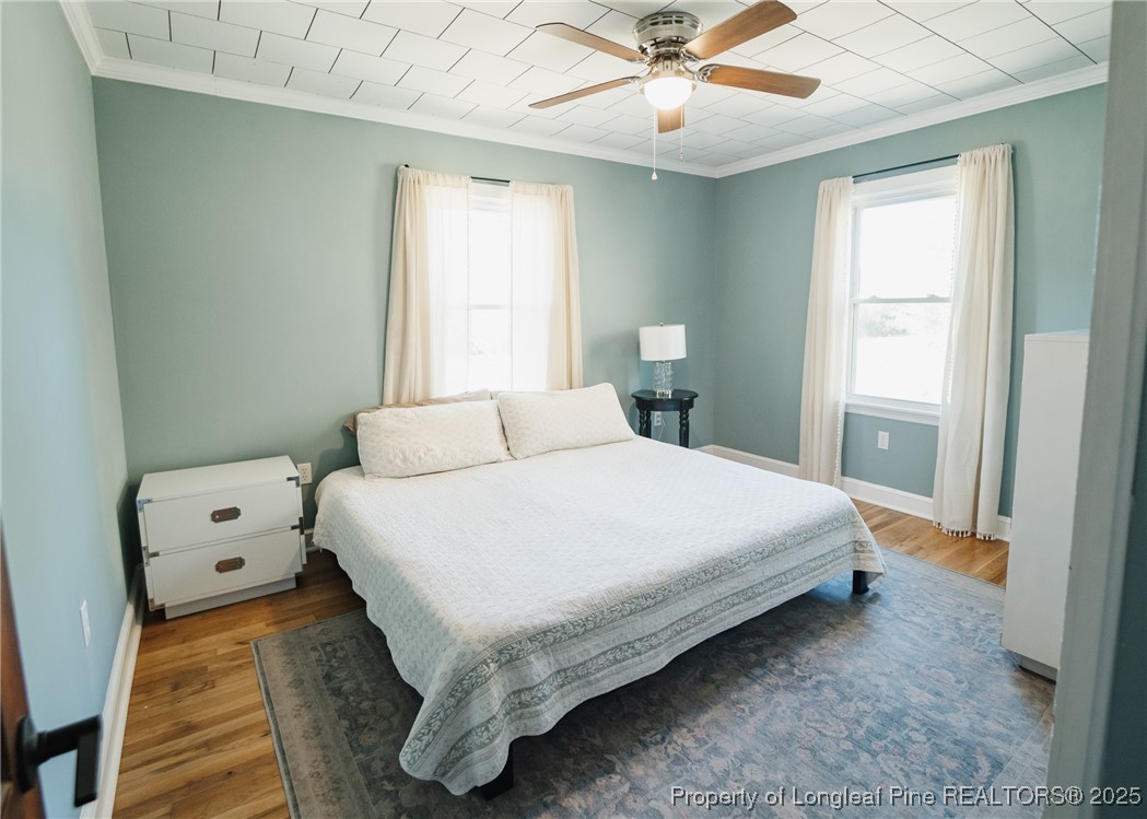 9778 Highway 24 Carthage, NC 28327 - Photo 34 of 47 a large bed sitting in a bedroom next to a window and a chandelier