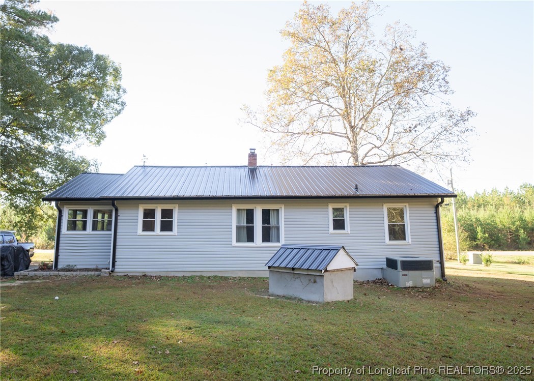 9778 Highway 24 Carthage, NC 28327 - Photo 46 of 47 a front view of a house with a garden and deck