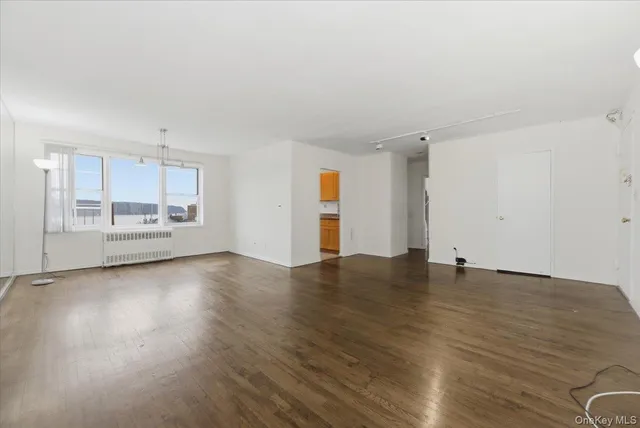 a view of an empty room and wooden floor