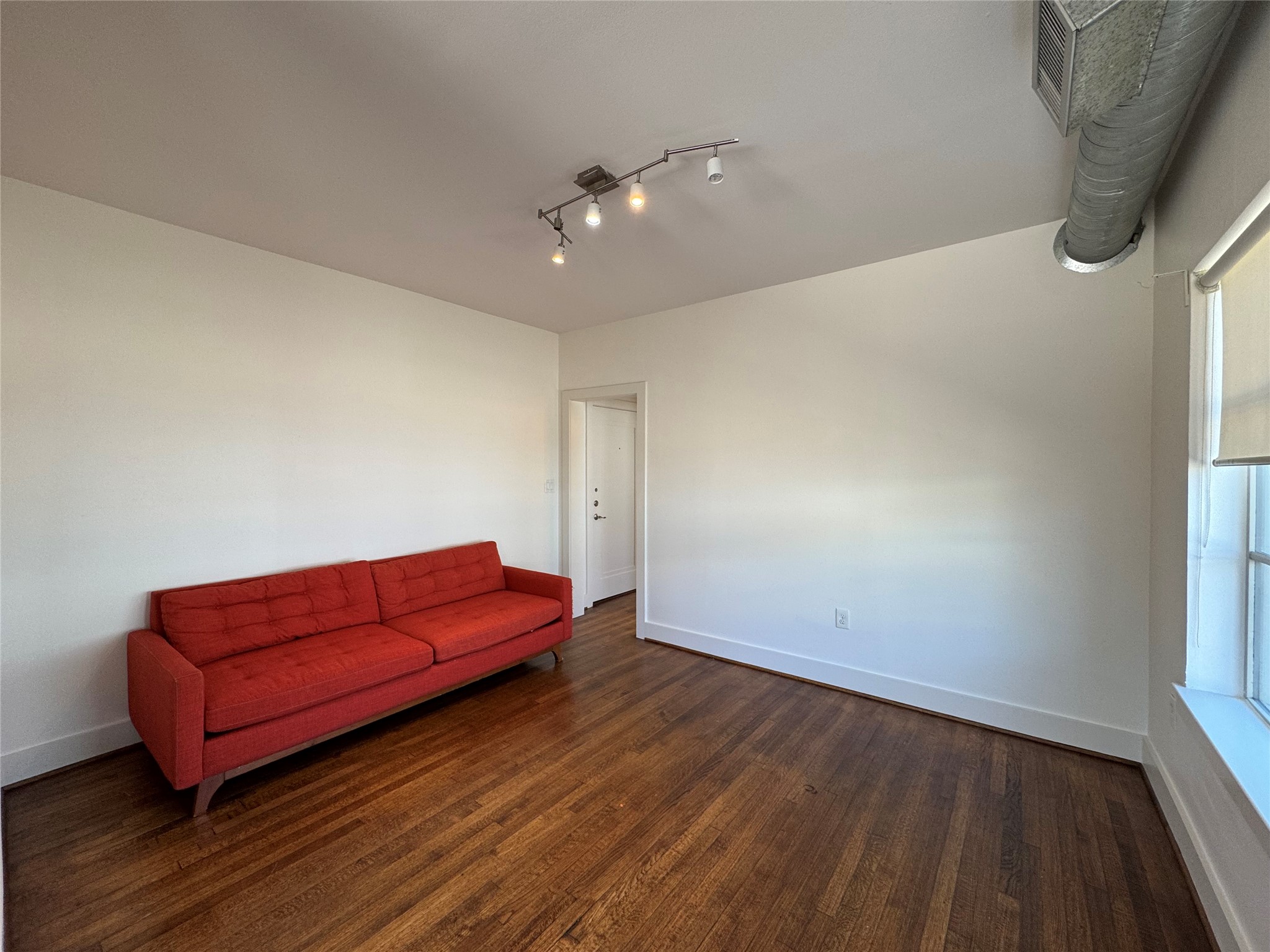 1509 Holman Street, Unit 2 Houston, TX 77004 - Photo 9 of 10 a living room with hard wood floors and a couch