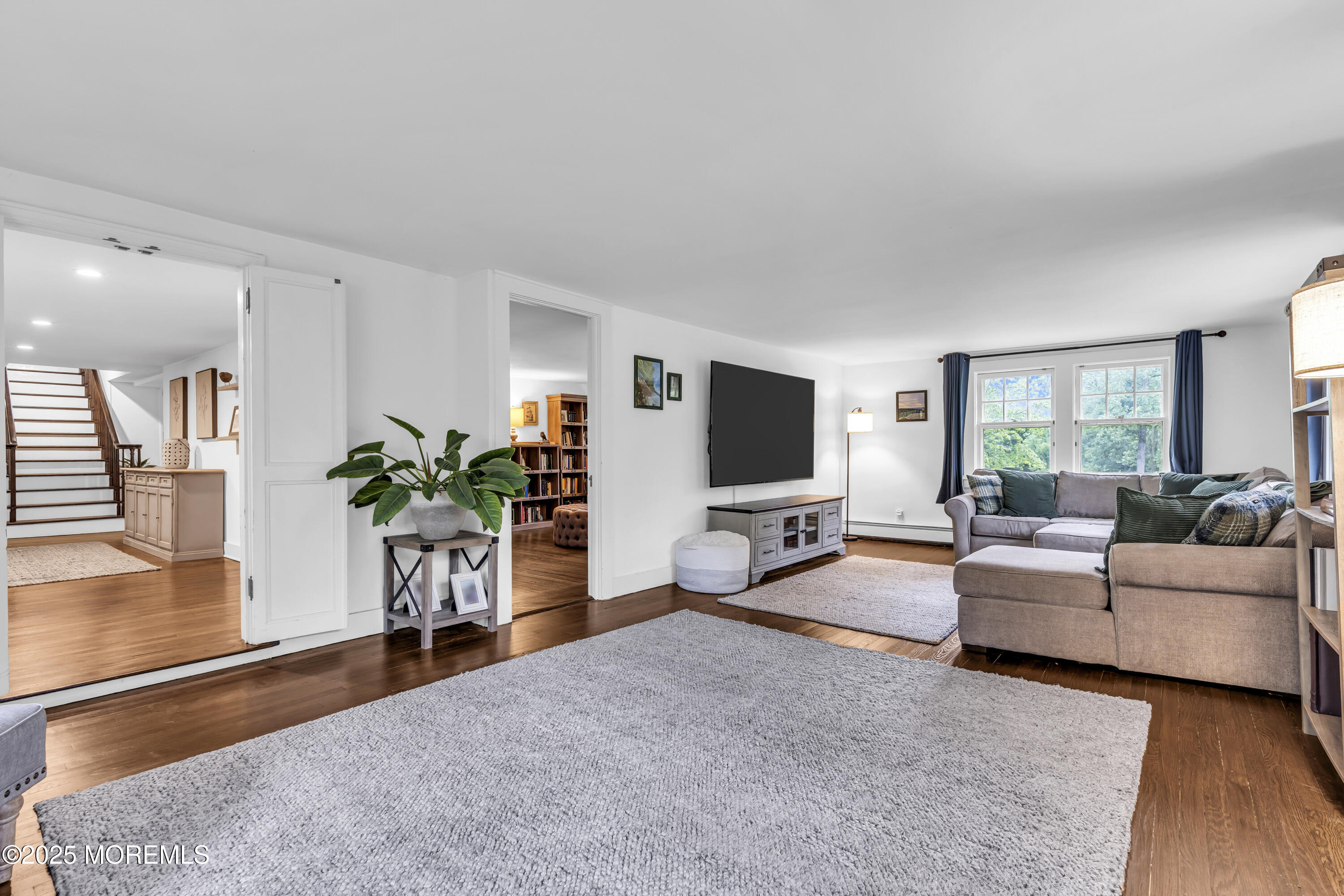 2041 Raritan Road Scotch Plains, NJ 07076 - Photo 32 of 106 a living room with furniture a potted plant and a flat screen tv