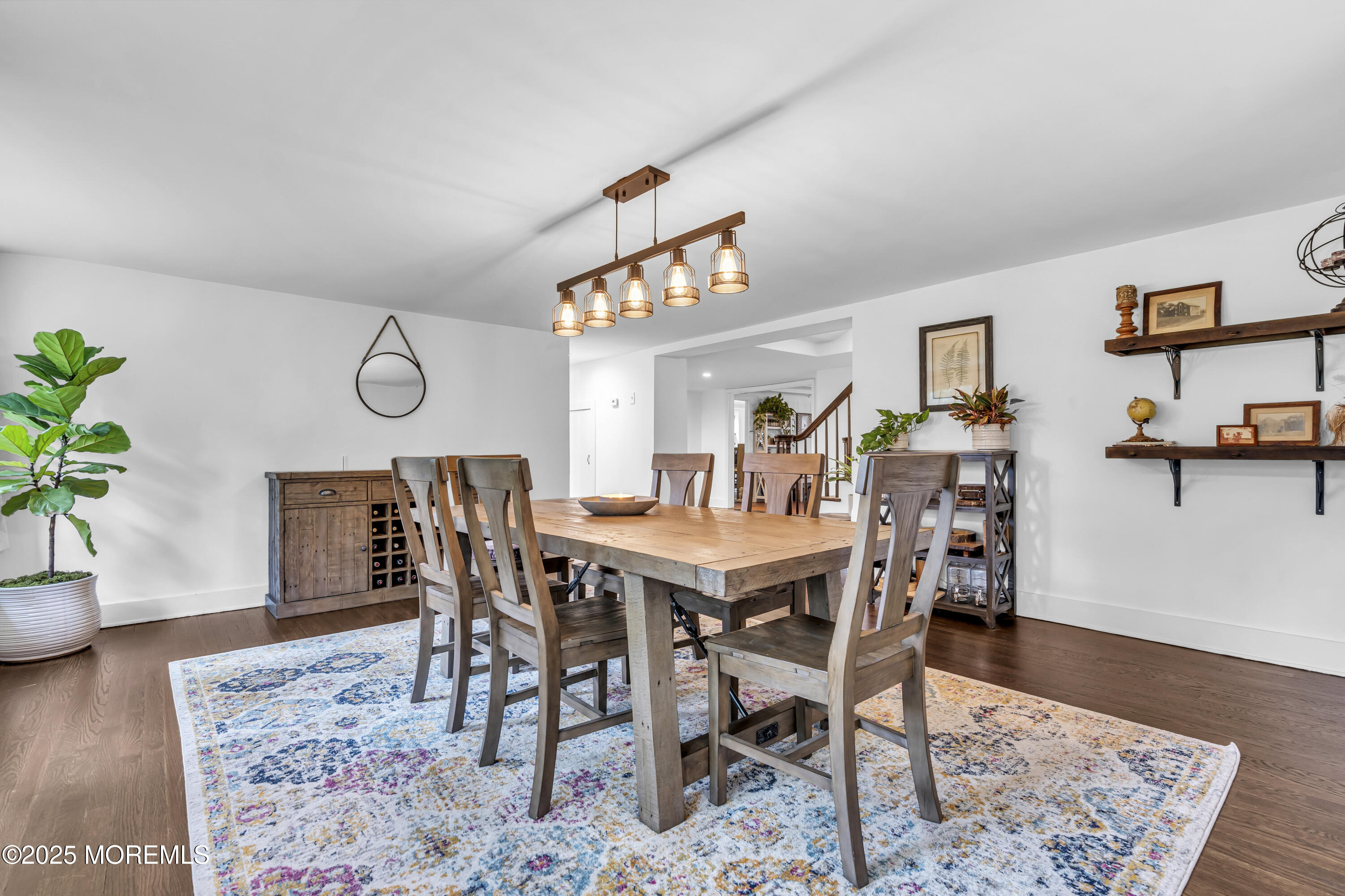 2041 Raritan Road Scotch Plains, NJ 07076 - Photo 39 of 106 a view of a dining room and livingroom with furniture wooden floor a rug and a painting