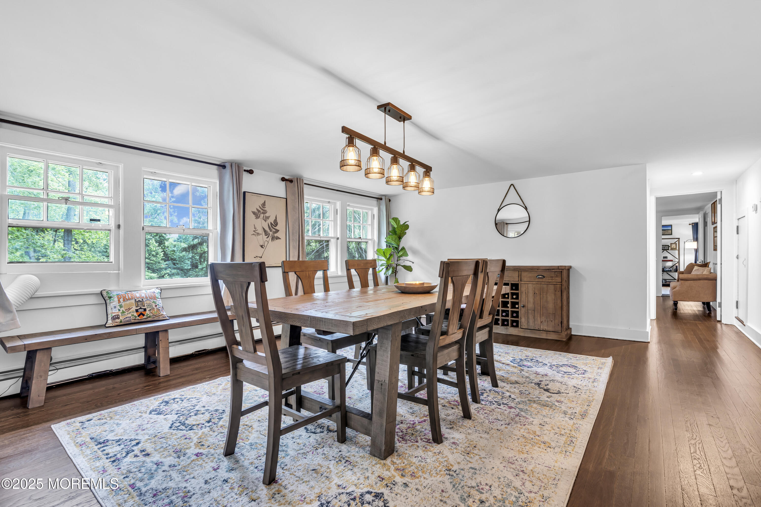 2041 Raritan Road Scotch Plains, NJ 07076 - Photo 40 of 106 a view of a dining room and livingroom with furniture wooden floor and a rug