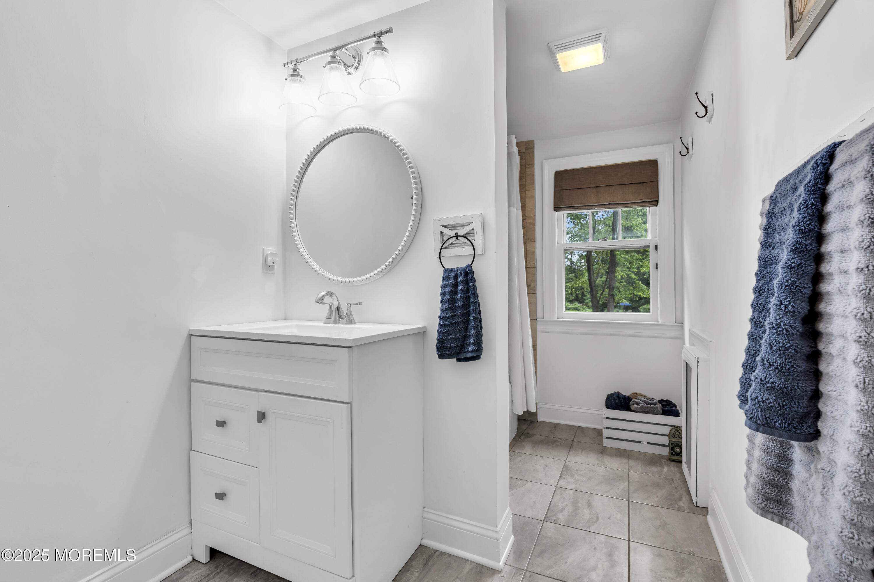 2041 Raritan Road Scotch Plains, NJ 07076 - Photo 41 of 106 a bathroom with a sink a toilet and a mirror