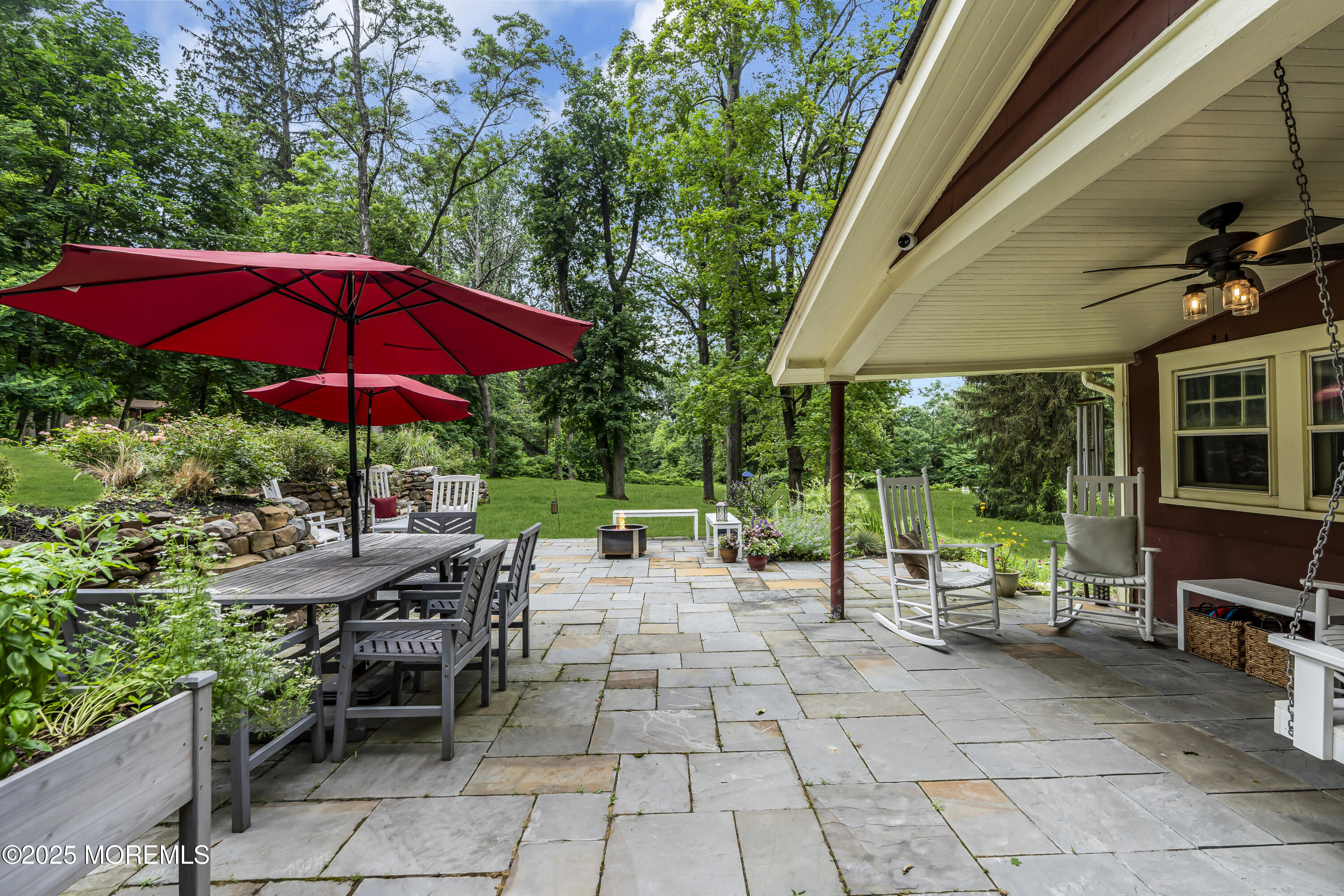 2041 Raritan Road Scotch Plains, NJ 07076 - Photo 85 of 106 a view of a patio with chairs and table under an umbrella