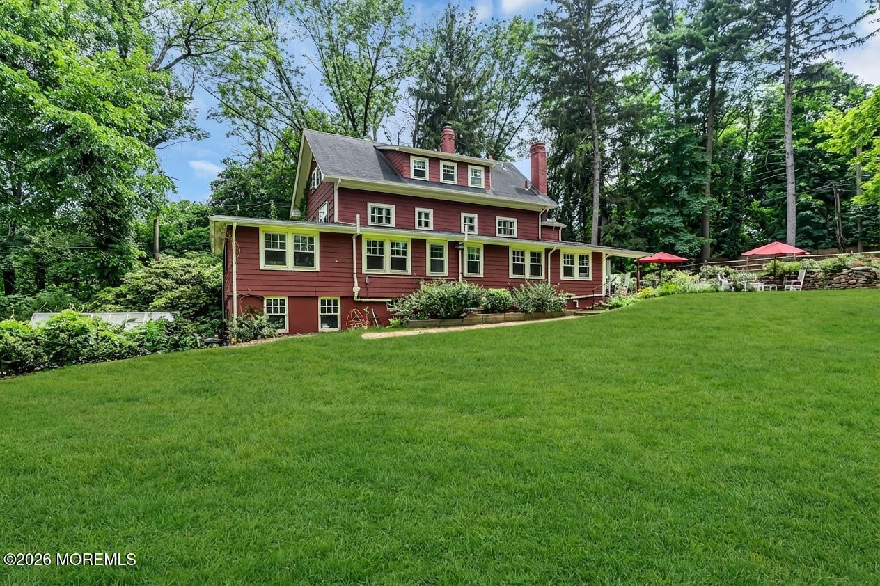 2041 Raritan Road Scotch Plains, NJ 07076 - Photo 94 of 106 a front view of a house with a garden and trees
