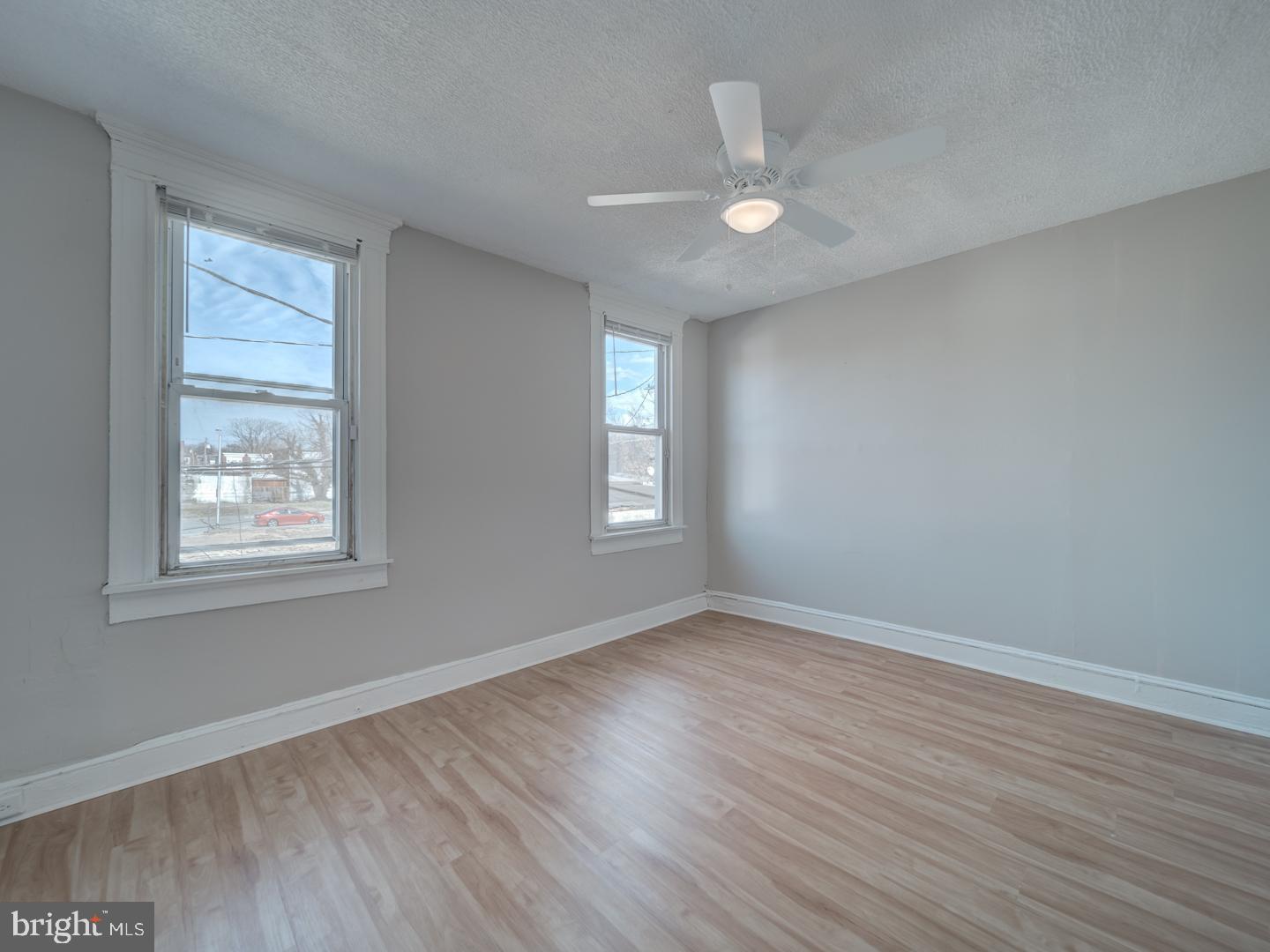 1716 Homestead Street Baltimore, MD 21218 - Photo 22 of 48 a view of an empty room with wooden floor and a window