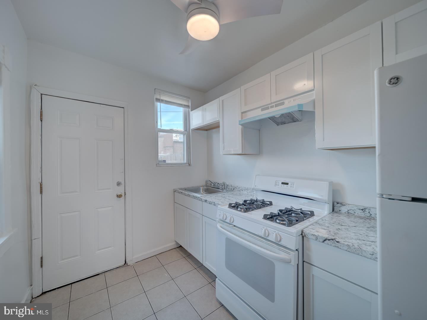 1716 Homestead Street Baltimore, MD 21218 - Photo 33 of 48 a kitchen with cabinets appliances and a window
