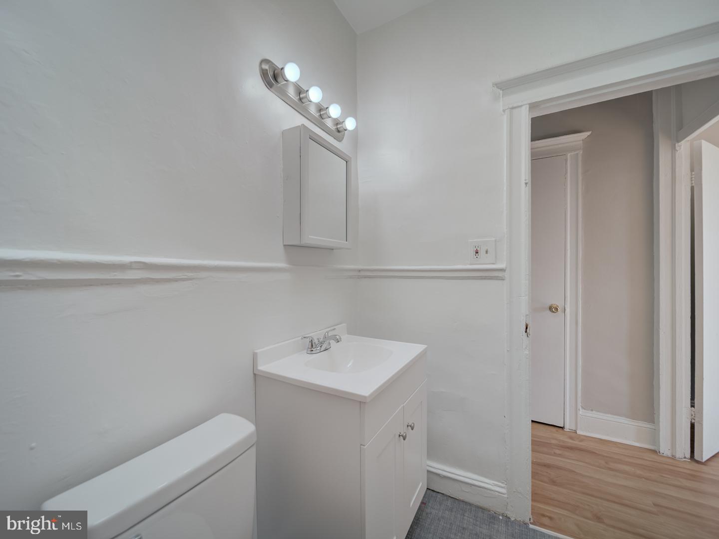 1716 Homestead Street Baltimore, MD 21218 - Photo 6 of 48 a bathroom with a sink a toilet and vanity