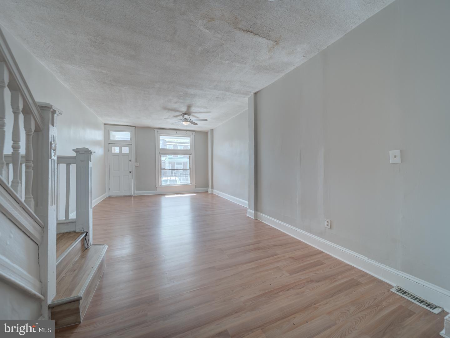 1716 Homestead Street Baltimore, MD 21218 - Photo 7 of 48 a view of an empty room with wooden floor and a window