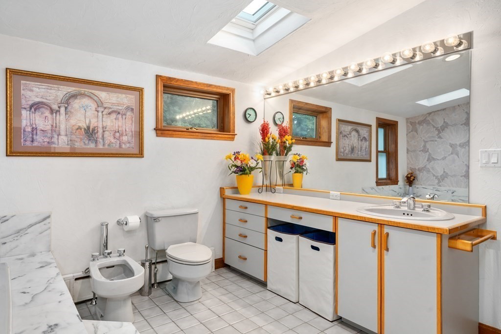 22 Olde Field Road Newton, MA 02459 - Photo 17 of 31 a spacious bathroom with a toilet sink and mirror