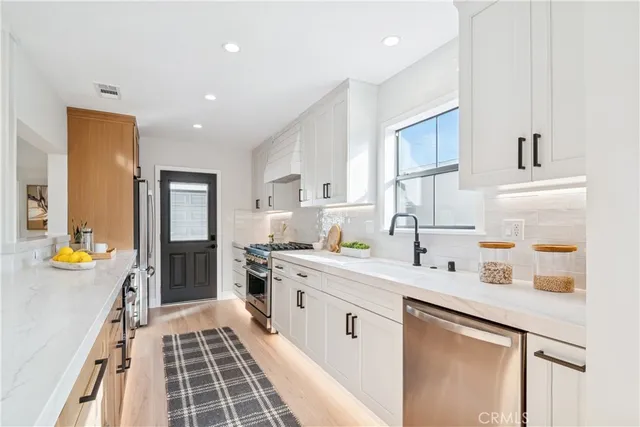 a living room with kitchen island furniture and a kitchen view