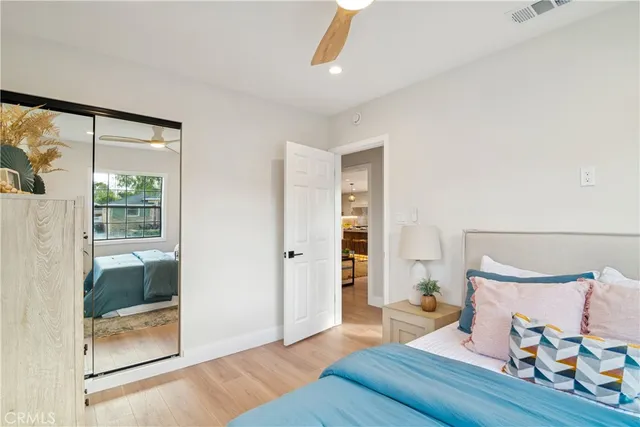 a bedroom with furniture and a large window