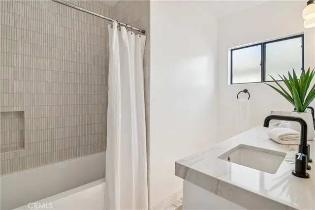 a bedroom with a bed and a night stand