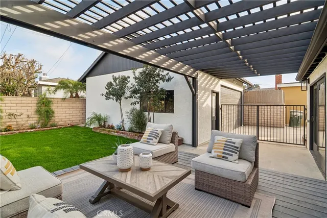 a large kitchen with kitchen island a large counter space a sink a window and stainless steel appliances