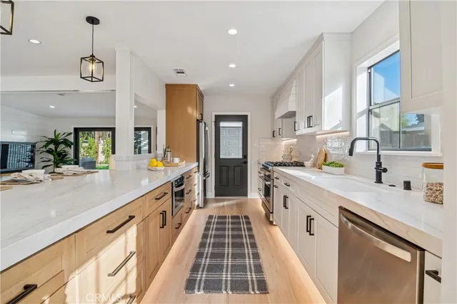 a large kitchen with a table and chairs in it