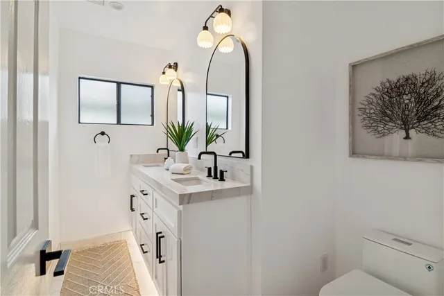 a bathroom with a double vanity sink mirror and shower