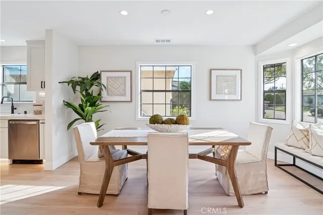 a work room with furniture and large windows