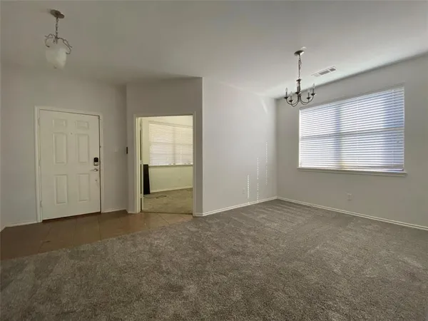 an empty room with windows and cabinet
