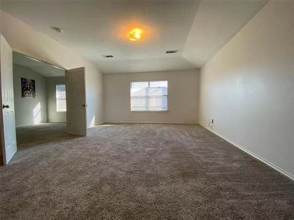 an empty room with window and pillar in it
