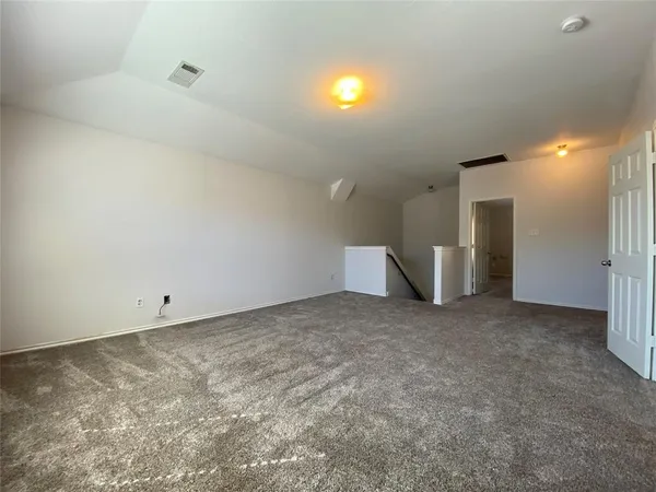 a view of an empty room with a fireplace