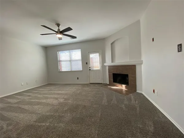 a view of empty room with a fireplace