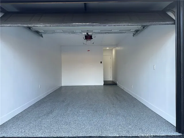 a kitchen with a sink a stove cabinets and wooden floor