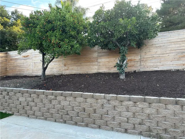 an empty room with wooden floor and a ceiling fan