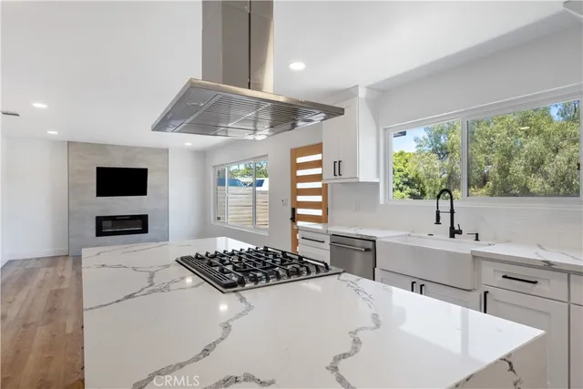 a view of an empty room with a fireplace and a window