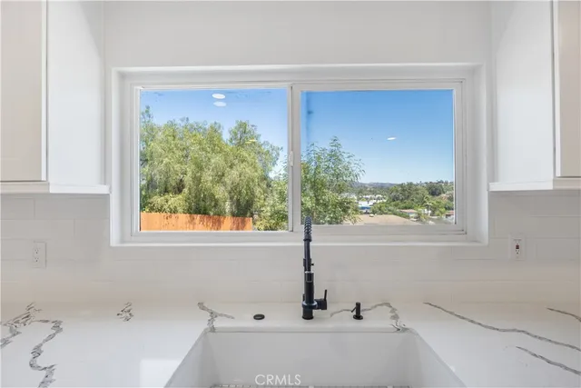 a kitchen with a stove and a white cabinets