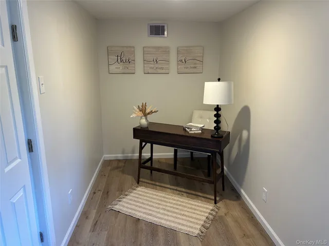 a workspace with furniture and wooden floor