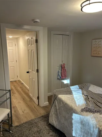 a bedroom with a bed and a painting on the wall