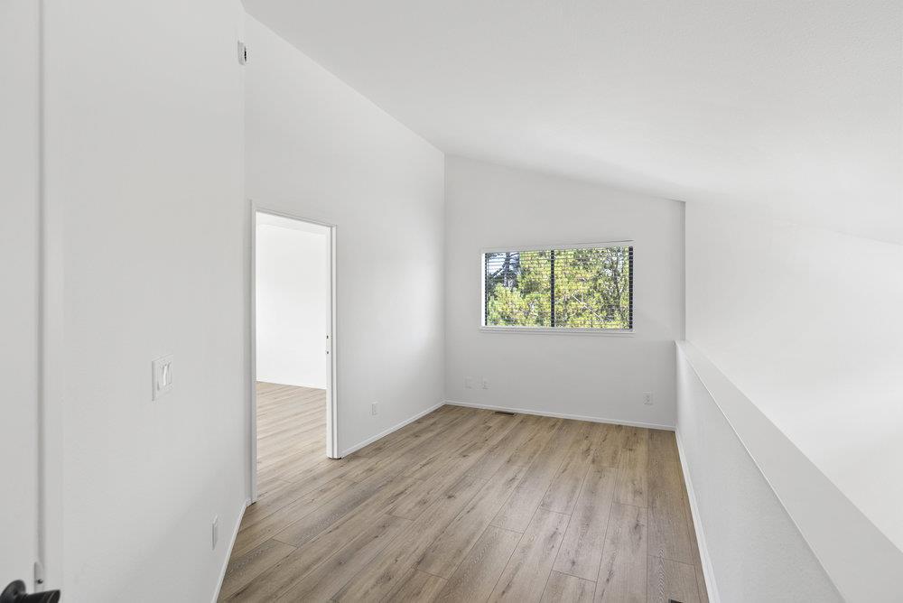 1313 Vía Tornasol Aptos, CA 95003 - Photo 21 of 38 an empty room with wooden floor and windows